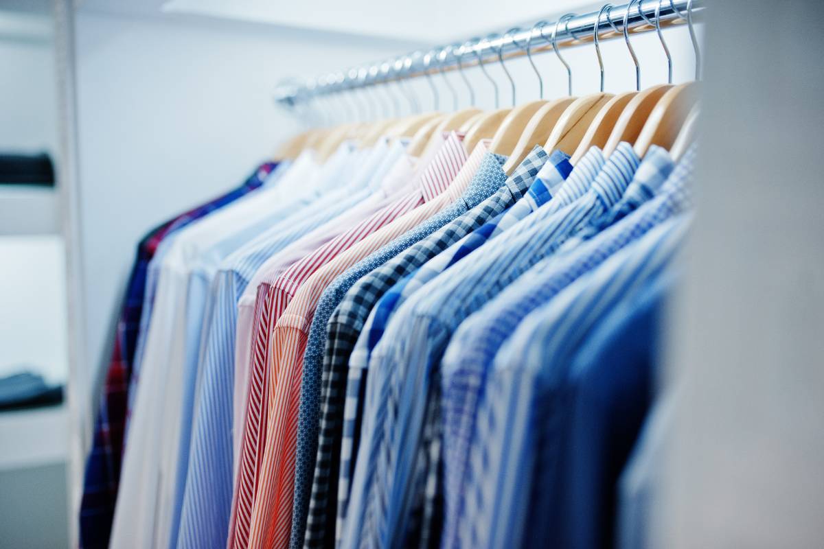 Customer handing over garments at a professional dry cleaning shop highlighting dry cleaning cost in Delhi