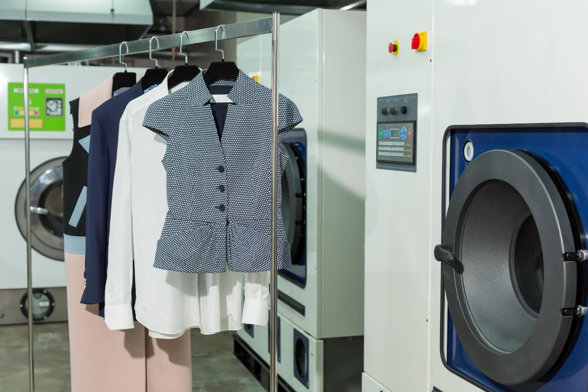 Laundry staff calculating dry cleaning cost for a customer