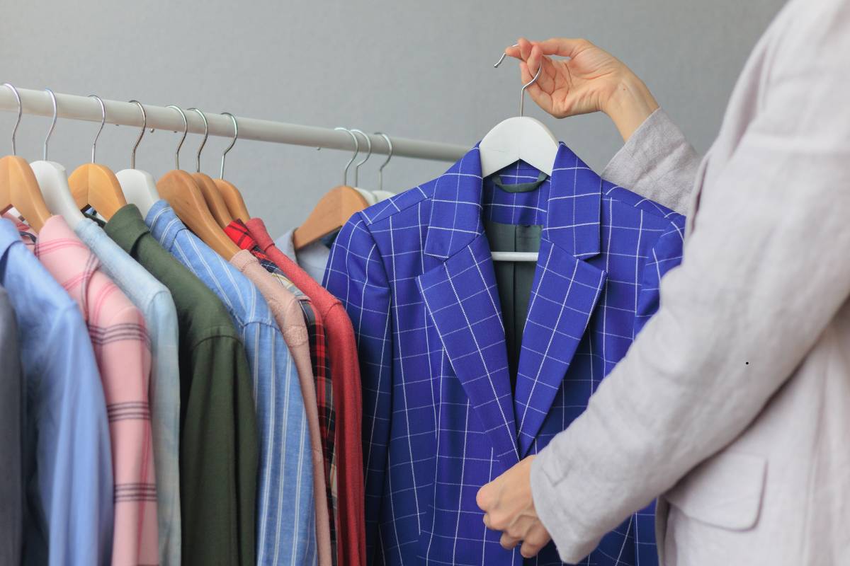 Staff handling blazers carefully at a dry cleaning service in Delhi