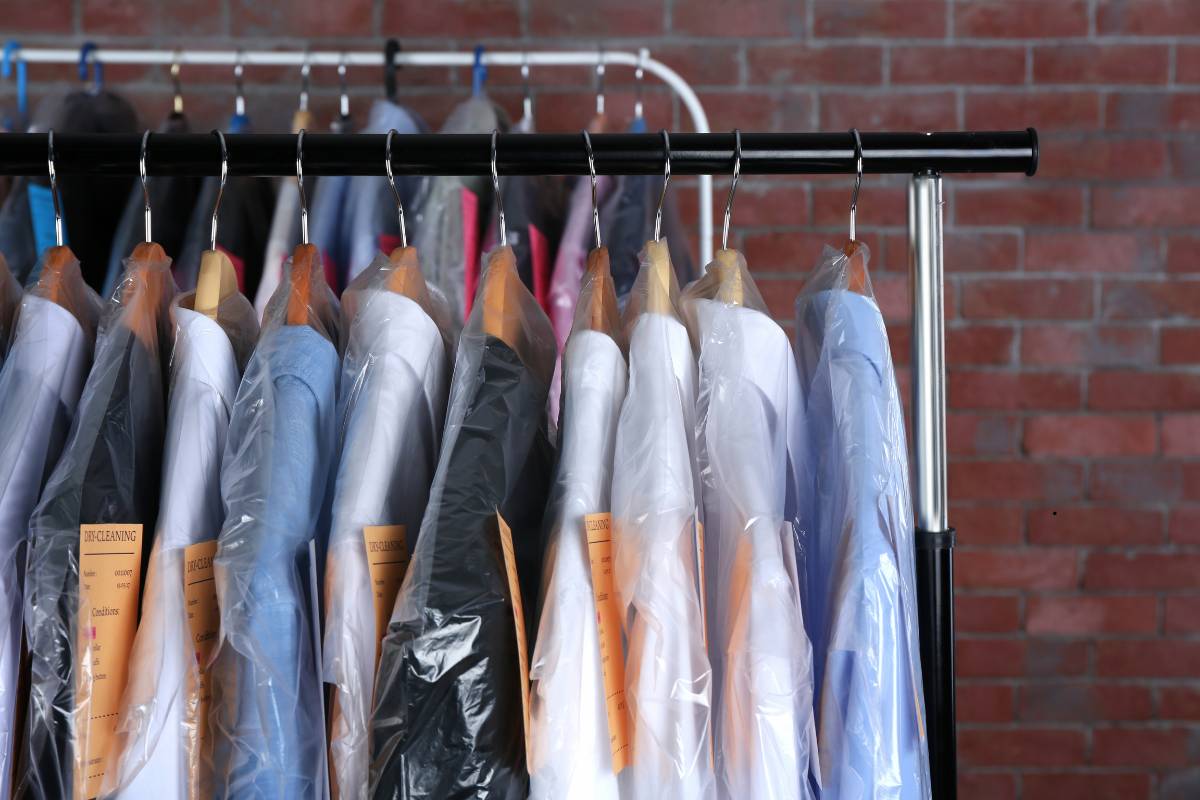Blazer being handled by staff at a dry cleaning shop