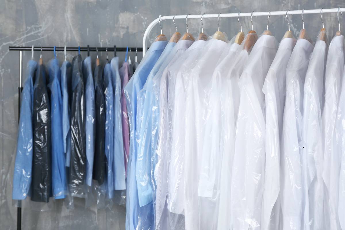 Professional arranging clothes in a dry cleaning shop to explain how often should you dry clean clothes