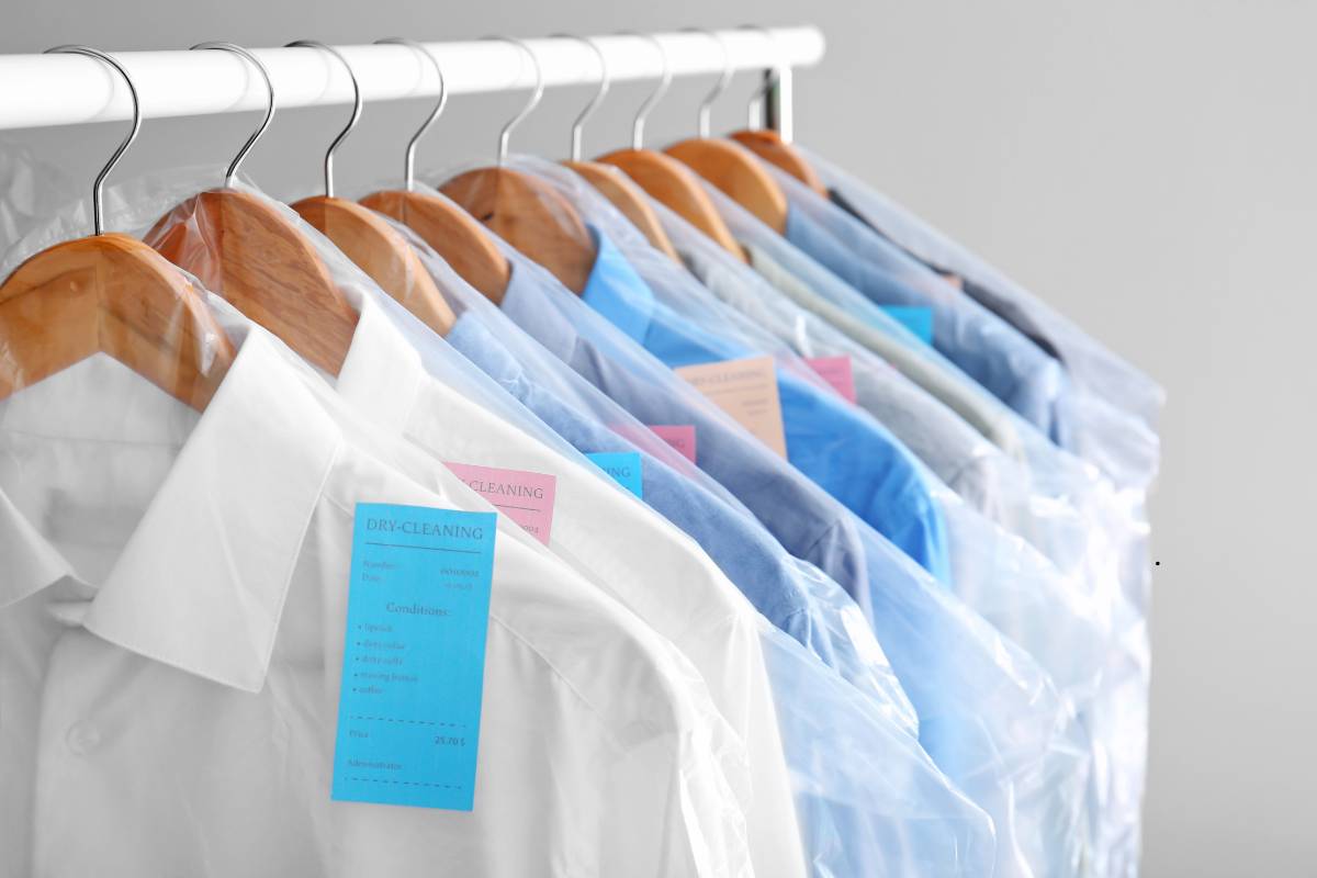 Person checking wardrobe to determine how often should you dry clean clothes